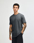 A unisex short sleeve t-shirt in grey, featuring a logo, displayed on a model with tattoos.