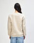 A unisex crewneck sweatshirt in a light beige colour, featuring a logo on the back and ribbed cuffs.