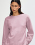 A unisex crewneck sweatshirt in a soft pink hue, featuring a casual design and a logo on the sleeve.