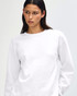 A unisex white crewneck sweatshirt, featuring a relaxed fit and a branding logo.