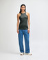 A woman wearing a dark green American Apparel CVC racerneck tank top paired with light blue cargo pants.