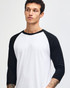 A unisex raglan T-shirt featuring black sleeves and a white body, worn by a model with a shaved head.