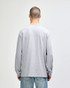 A woman wearing a grey Gildan Ultra Cotton adult long sleeve t-shirt, viewed from the back, paired with navy leggings.