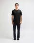 A unisex black henley T-shirt displayed on a model, featuring a buttoned neckline and short sleeves.