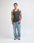 A unisex fine jersey tank in grey, worn with black loose-fitting pants and white sneakers. The tank features a logo.