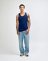 A model wearing a navy blue unisex fine jersey tank top paired with black cargo pants and sneakers.