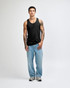 A black unisex fine jersey tank top worn with baggy black pants and sneakers, featuring a visible logo.