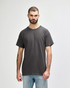 A grey Gildan Heavy Cotton Adult T-Shirt worn by a model, featuring a classic crew neck design and short sleeves.