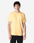 A model wearing a yellow Gildan Heavy Cotton adult T-shirt, paired with blue jeans. The shirt has a logo.