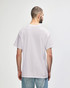 A man wearing a light grey Gildan Heavy Cotton Adult T-Shirt, viewed from the back. The shirt has a logo.
