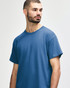 A blue Gildan Heavy Cotton adult t-shirt displayed on a model, featuring a simple design and a logo.