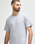 A grey Gildan Heavy Cotton Adult T-Shirt displayed on a model, featuring a simple design and a logo.