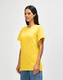 A yellow Gildan Heavy Cotton Adult T-Shirt on a model, featuring a logo. The shirt has a classic fit and short sleeves.