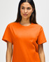 An orange Gildan Heavy Cotton adult T-shirt displayed on a model, featuring a classic fit and crew neckline.