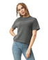A woman is wearing a dark grey boxy t-shirt paired with blue jeans, with curly hair framing her face.