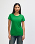 A green Gildan Heavy Cotton Ladies' T-Shirt displayed on a model wearing denim jeans. The shirt has a logo.