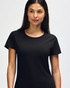 A black Gildan Heavy Cotton Ladies' T-Shirt displayed on a smiling woman, featuring a simple design and casual fit.