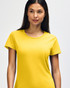 A yellow Gildan Heavy Cotton Ladies' T-Shirt displayed on a model, featuring a simple design and a logo.