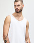 A white Gildan Heavy Cotton adult tank top on a model, showcasing the simple design and relaxed fit.