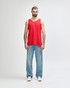 A red Gildan Heavy Cotton adult tank top displayed on a model, paired with black pants and shoes.