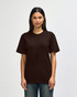 A man is wearing a brown Gildan Softstyle adult t-shirt, featuring a plain design. The shirt has a logo on it.