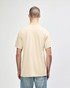 A beige Gildan Softstyle adult t-shirt displayed from the back, with a plain design and a subtle logo.