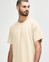 A light beige Gildan Softstyle adult t-shirt featuring a crew neck and short sleeves, displayed on a male model.