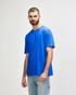 A blue Gildan Softstyle adult T-shirt displayed on a model, featuring a basic crew neck design and short sleeves.