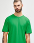 A plain green Gildan Softstyle adult T-shirt displayed on a model with a neutral expression.