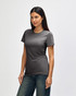 A grey Gildan Softstyle ladies' t-shirt displayed on a model, featuring a fitted design and short sleeves.