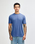 A blue American Apparel tri-blend t-shirt displayed on a model, featuring a relaxed fit and short sleeves.