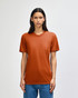 A model wearing an orange American Apparel tri-blend t-shirt, standing against a neutral background.