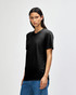 A black American Apparel Tri-Blend T-Shirt displayed on a model, paired with blue jeans.