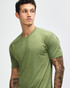 A green unisex T-shirt with short sleeves, featuring a logo on the chest area. Suitable for casual wear.