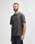 A man wearing a grey Gildan Softstyle Adult Double Pique Polo, standing against a plain background.