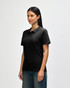 A black ladies' polo shirt with short sleeves, featuring a collar and a logo on the left side.