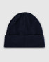A navy blue watch cap featuring a cuffed design and a smooth knit texture. The cap includes branding.