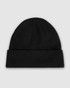 A black watch cap with a folded rim, featuring a logo. The fabric is ribbed for a snug fit.