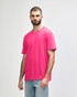 A midweight adult T-shirt in bright pink, featuring a crew neckline and short sleeves. It has a logo on the front.
