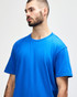 A midweight adult t-shirt in blue, featuring a round neck and short sleeves, with a branding logo.