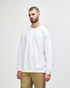 A white Gildan Softstyle adult sweatshirt displayed on a model, featuring a round neckline and long sleeves.