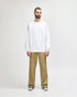 A white Gildan Softstyle adult sweatshirt displayed on a model, paired with black jeans and sneakers.
