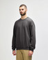 A green Gildan Softstyle adult sweatshirt displayed on a model, featuring long sleeves and a classic fit.