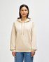 A beige hooded sweatshirt with a front pocket and adjustable drawstrings, worn by a model standing against a plain background.