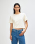 A cream-coloured women's boxy t-shirt with a crew neck and short sleeves, featuring a logo.