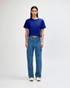 A blue boxy T-shirt paired with light blue cargo jeans and sneakers, displayed on a model. The outfit features casual styling.