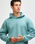 A unisex hooded sweatshirt in a soft green shade, featuring a relaxed fit and a front pocket. It has a logo.