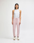 A pair of pink unisex sweatpants made from fleece, featuring a logo and side pockets.