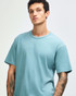 A unisex short sleeve t-shirt in a light blue colour, featuring a casual fit and a logo.