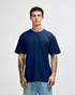 A navy unisex short sleeve T-shirt displayed on a model with tattoos, featuring a simple design and no visible branding.